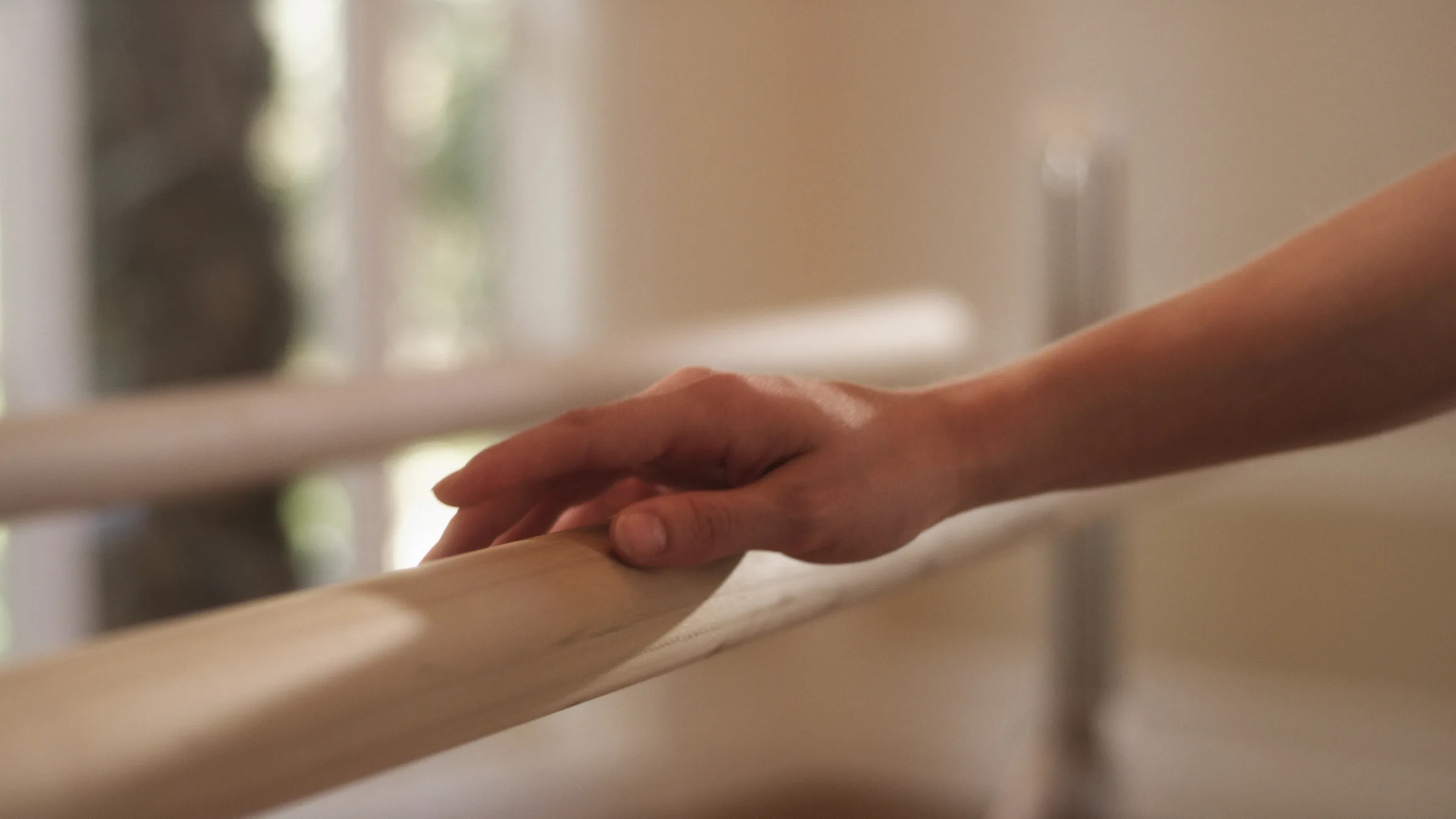 A hand resting on the barre in the FIT studio